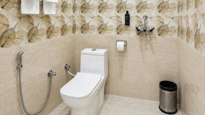 A modern bathroom with a toilet, bidet, and shower. - Hotel Tapovan Inn (Varanasi)