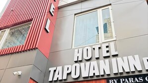 A hotel named 'HOTEL TAPOVANINN' with a modern facade, including a prominent red and grey color scheme and a visible entrance. - Hotel Tapovan Inn (Varanasi)
