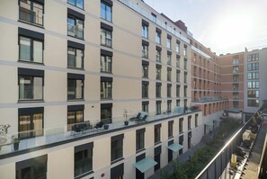 A multi-story residential building with balconies, large windows, and a flat roof. - Comfortable Apartment with Parking Space | 2 Bedrooms | City Centre (Lublin)