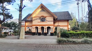 A two-story building with a gabled roof and a central entrance. - Villa Dinar Mountain Estate  (Bandung Barat)