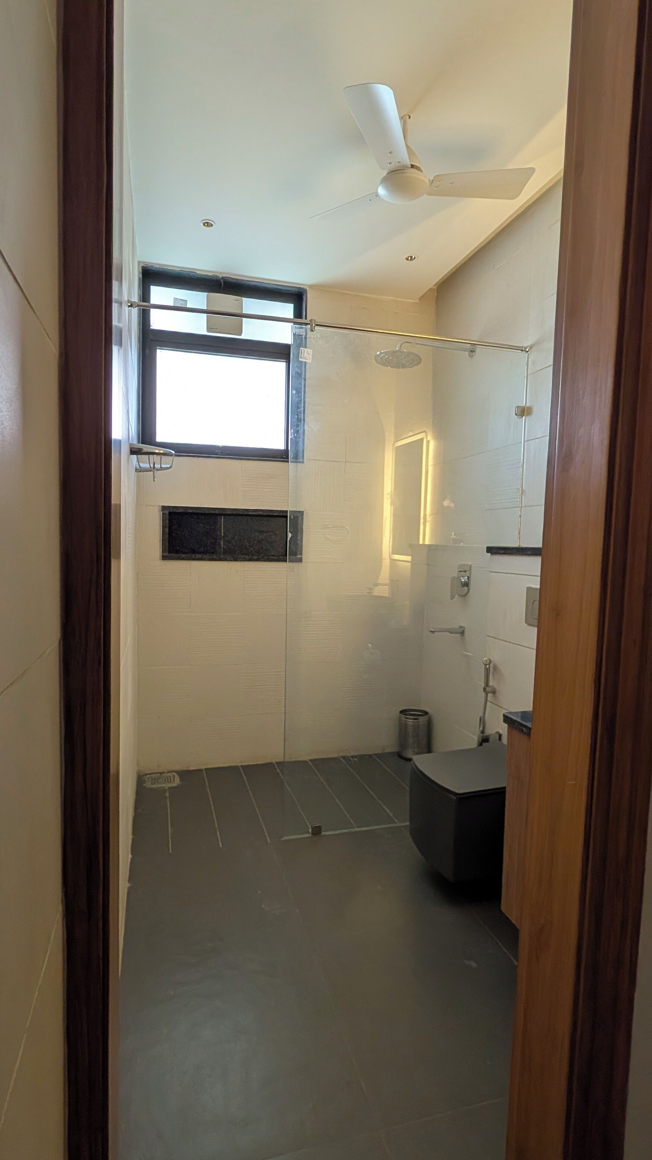A bathroom with a shower, a toilet, and a sink.
