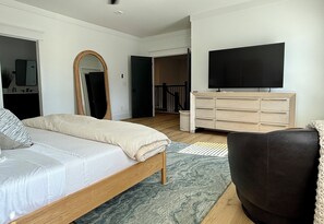 A bedroom with a bed, dresser, mirror, and television. - 2.8 Miles from Augusta National, this home is the perfect base for the Masters! (Augusta)