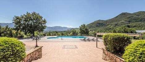 A swimming pool with a view of mountains in the background.