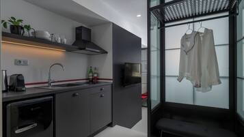 A modern kitchen with a built-in dishwasher, a coffee machine, and a wine bottle on the counter.