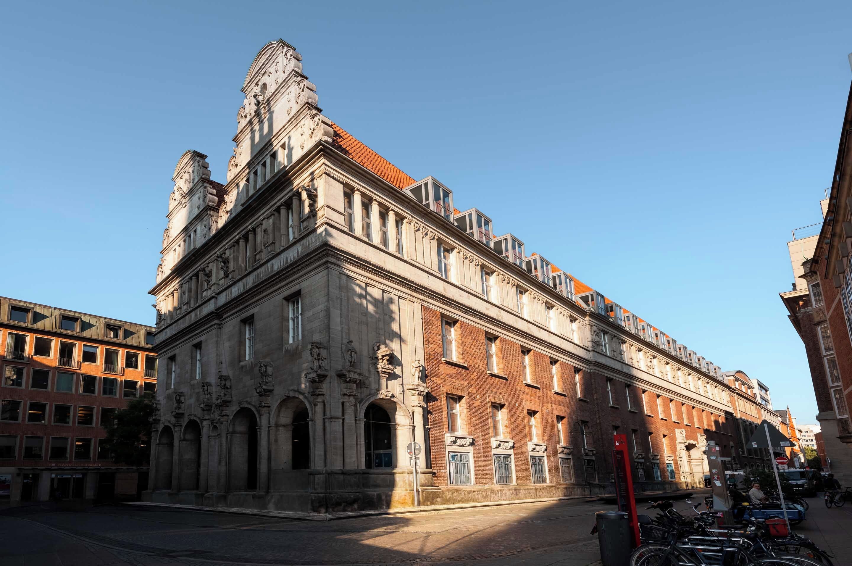 A historic building with classical architecture, featuring a prominent central section with columns and a detailed facade.