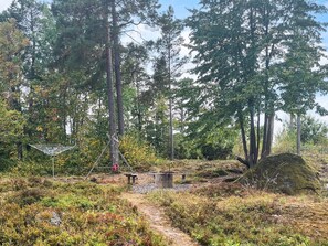 A forested area with a metal structure, possibly a bridge or walkway, and a bench. - 4 Star Holiday Home in Malmkoping (Malmkoping)