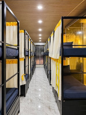 A corridor with bunk beds, wooden ceiling, and a marble floor. - ZEST STAYS GOREGAON WEST (Mumbai)