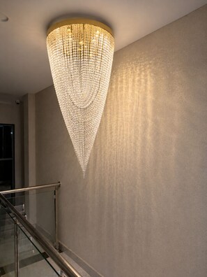 A modern interior with a large, ornate chandelier hanging from the ceiling.