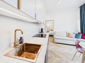 A modern kitchen with a sink, faucet, and countertop.