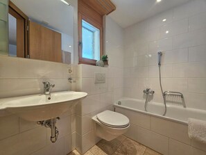 A modern bathroom with a sink, toilet, and bathtub. - Aramis EG Appartement/Fewo Appartement/Fewo by Interhome (Saas-Fee)