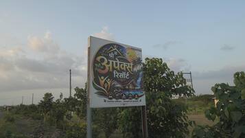 A signboard with text and symbols indicating a hotel or resort.