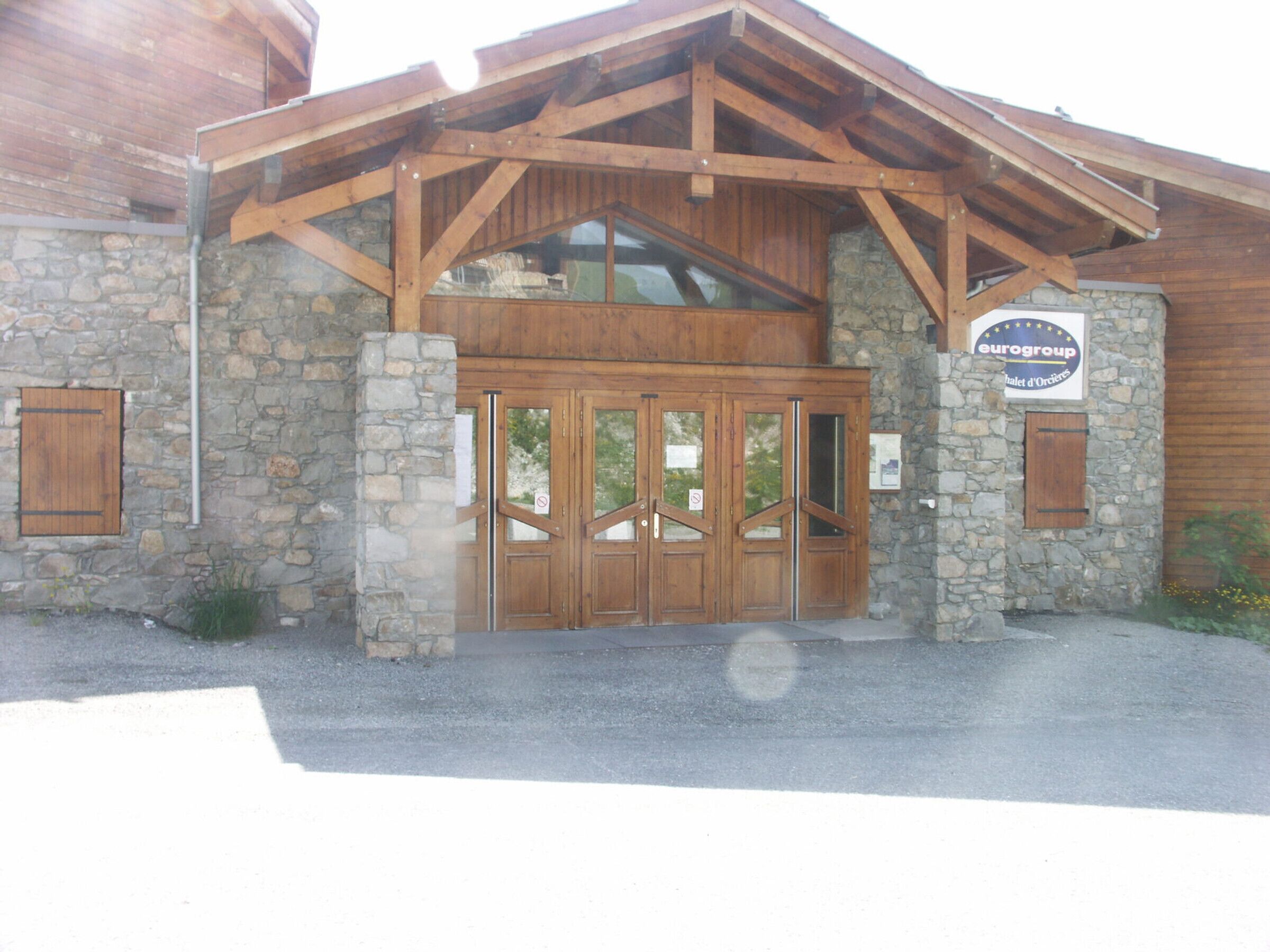 A building with a stone facade, wooden entrance, and a sign indicating it is part of the Eurogroup hotel chain.