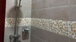 A shower with a handheld showerhead and a wall-mounted control panel. - Cozy 3BR Home in Quezon City (Quezon City)