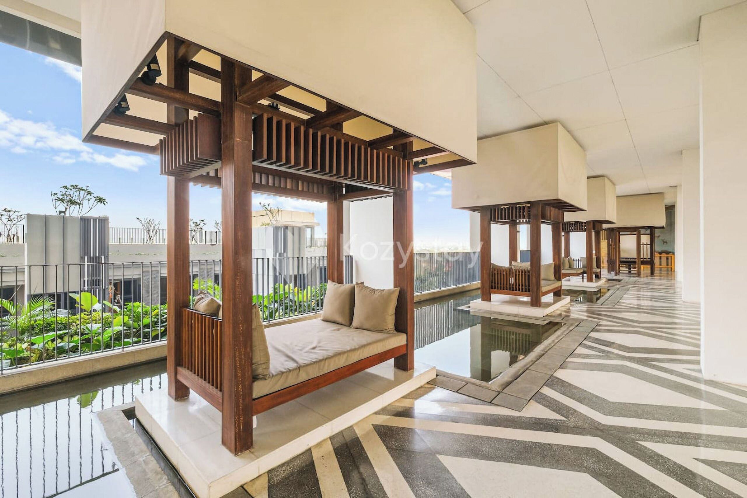 A modern hotel room with a glass floor, a wooden canopy bed, and a view of the cityscape.