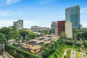 A modern building with a flat roof, surrounded by greenery and other buildings. - Weska by Kozystay - Cilandak (South Jakarta)