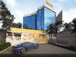 A modern building with a glass facade and a sign reading 'bloom'. - Bloom Hotel - Salt Lake Sector V (Barasat)