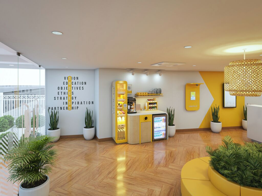 A modern reception area with a wooden floor, potted plants, a counter with a coffee machine, and a wall with motivational text.
