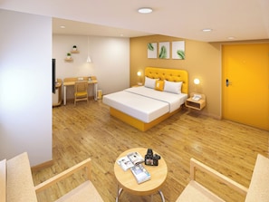 A hotel room with a bed, bedside tables, a desk, a chair, a round table, and a door. - Bloom Hotel - Salt Lake Sector V (Kolkata)