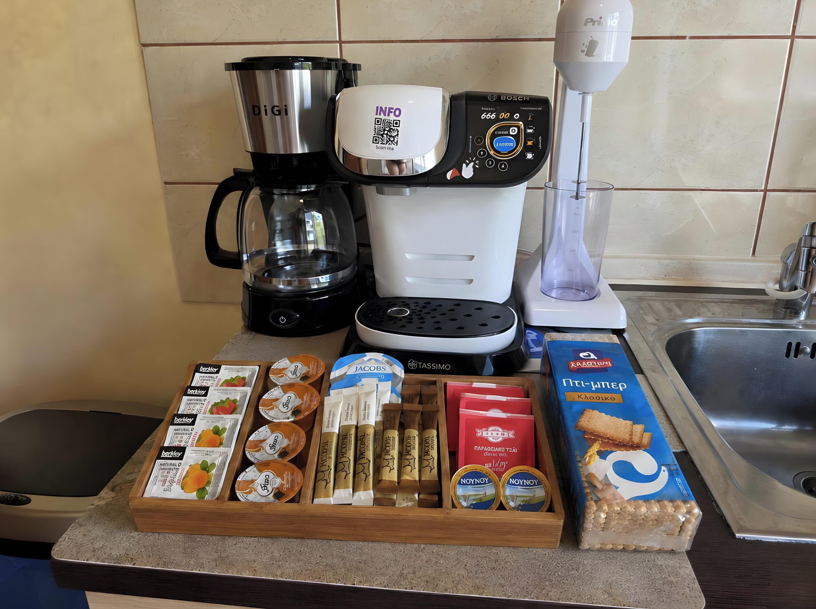 A kitchen counter with a coffee maker, a blender, and various food items including jars and boxes.