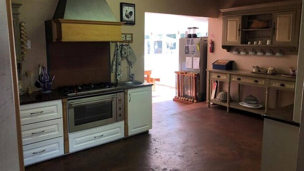 A kitchen with a stove, oven, and cabinets.