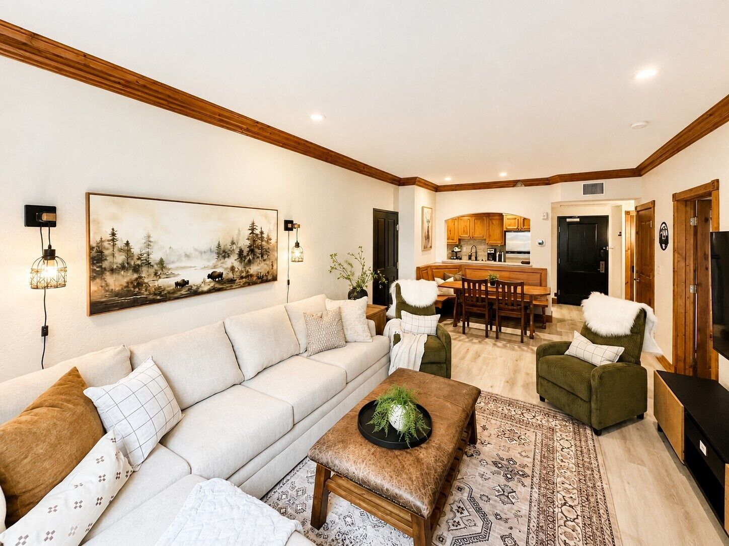 A living room with a sofa, a coffee table, and a dining area with chairs and a table.