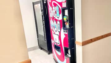 A hallway with vending machines and a door.