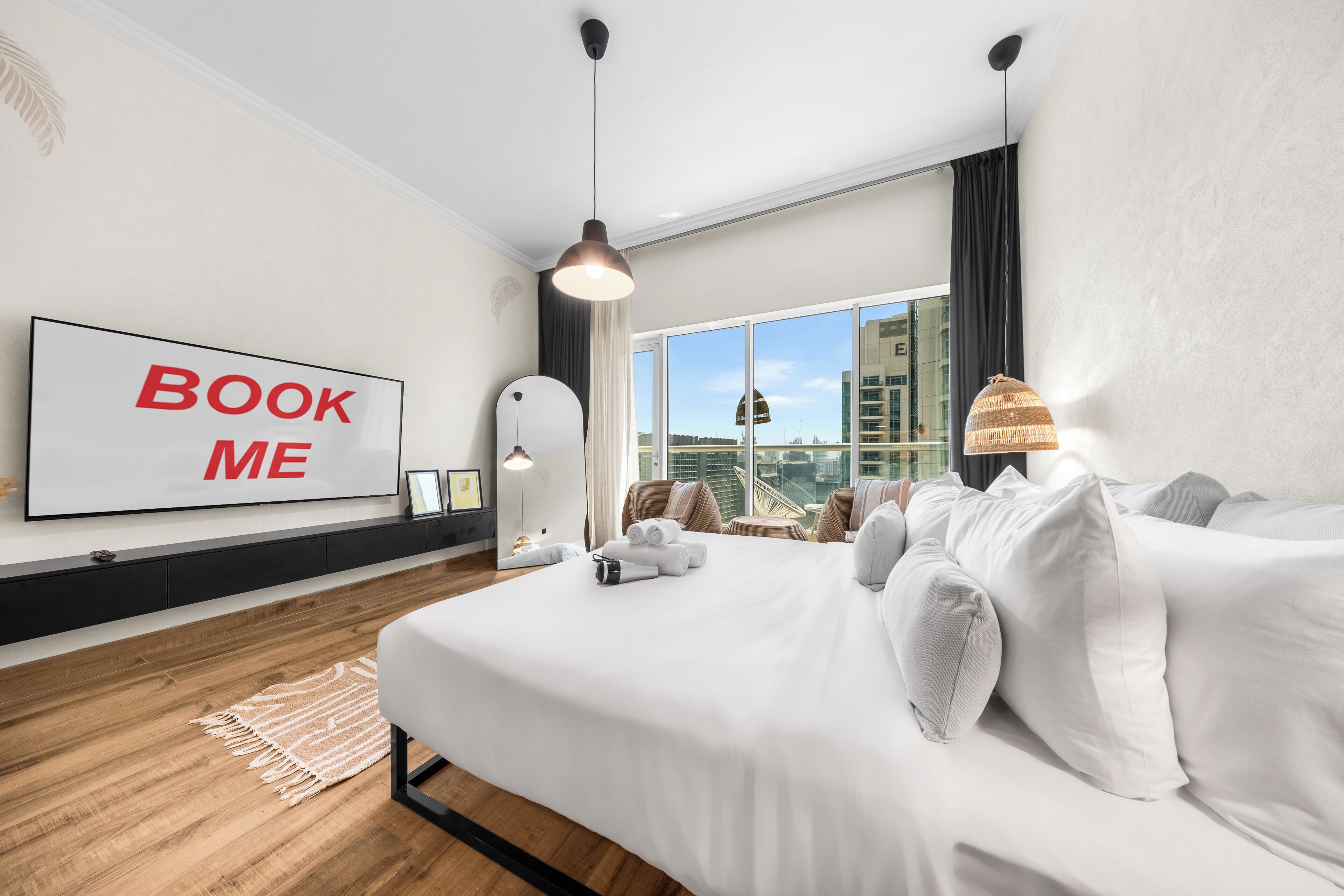 Een moderne hotelkamer met een groot bed, uitzicht op de stad, een 'BOOK ME' bord en een groot raam.