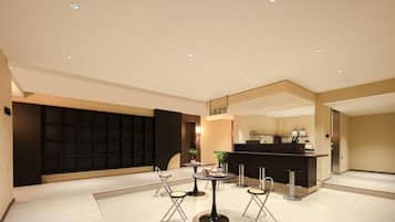 A modern interior with a reception desk, seating area, and a black partition wall.