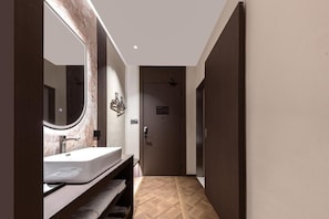A modern bathroom with a large mirror, a sink, and a door leading to another room. - Mutao Hotel Hubin in 77 (Hang Zhou Shi)