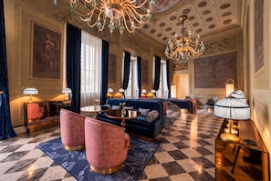 A luxurious lobby with a checkered floor, elegant sofas, and chandeliers. - Palazzo Sogni (Florence)