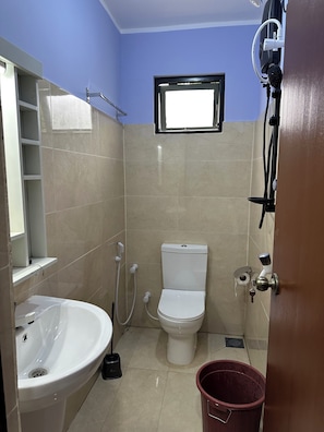 A bathroom with a toilet, sink, shower, and a small window. - Large, Peaceful 5‑Bedroom Home Just Steps from Jaffna Town (Jaffna)