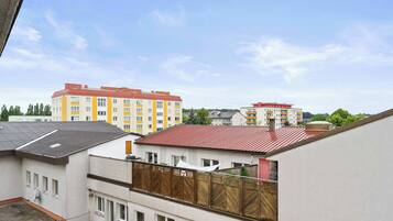 A residential area with multi-story buildings, some with red roofs and others with yellow and white facades.