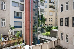 A multi-story residential building with balconies, a central stairwell, and a small garden area. - Kaiser 2BR | Metro & Tram | Nespresso | Central (Wien)
