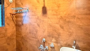 A bathroom with a shower, a toilet, and a sink. - Lotus - The Beach Resort  (Nagaon)