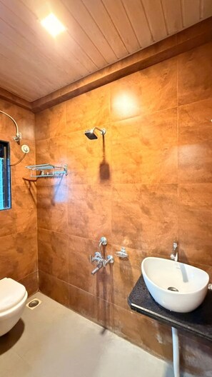 A bathroom with a shower, a toilet, and a sink. - Lotus - The Beach Resort  (Nagaon)