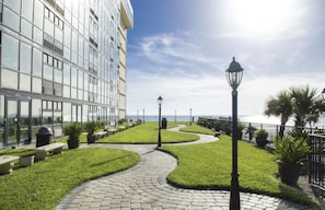 A hotel with a paved pathway, green lawns, and a view of the sea. - 20% OFF!! - Beautiful Ocean View Getaway Studio in Daytona! (Daytona Beach)