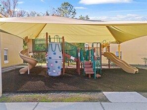 A playground with slides and climbing structures, enclosed by a canopy. - 4BR Modern Disney area Lake Berkley (Guard gated community) Pool Villa (Kissimmee)