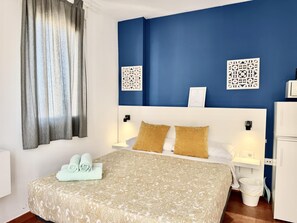 A hotel room with a bed, two nightstands, a white cabinet, a window with curtains, and decorative wall panels. - Sea-View Studio by La Carihuela Beach, Torremolinos (Torremolinos)