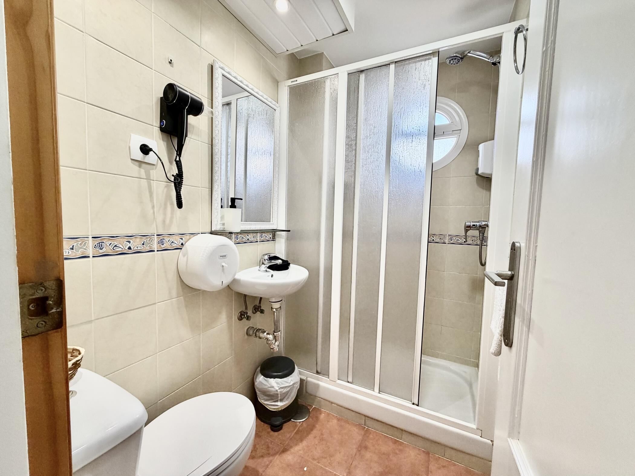 Shower, hair dryer, towels, toilet paper