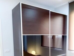 A room with a large, dark-colored cabinet with multiple compartments. - One-Bedroom Apartment by La Nogalera Square in Central Torremolinos (Torremolinos)