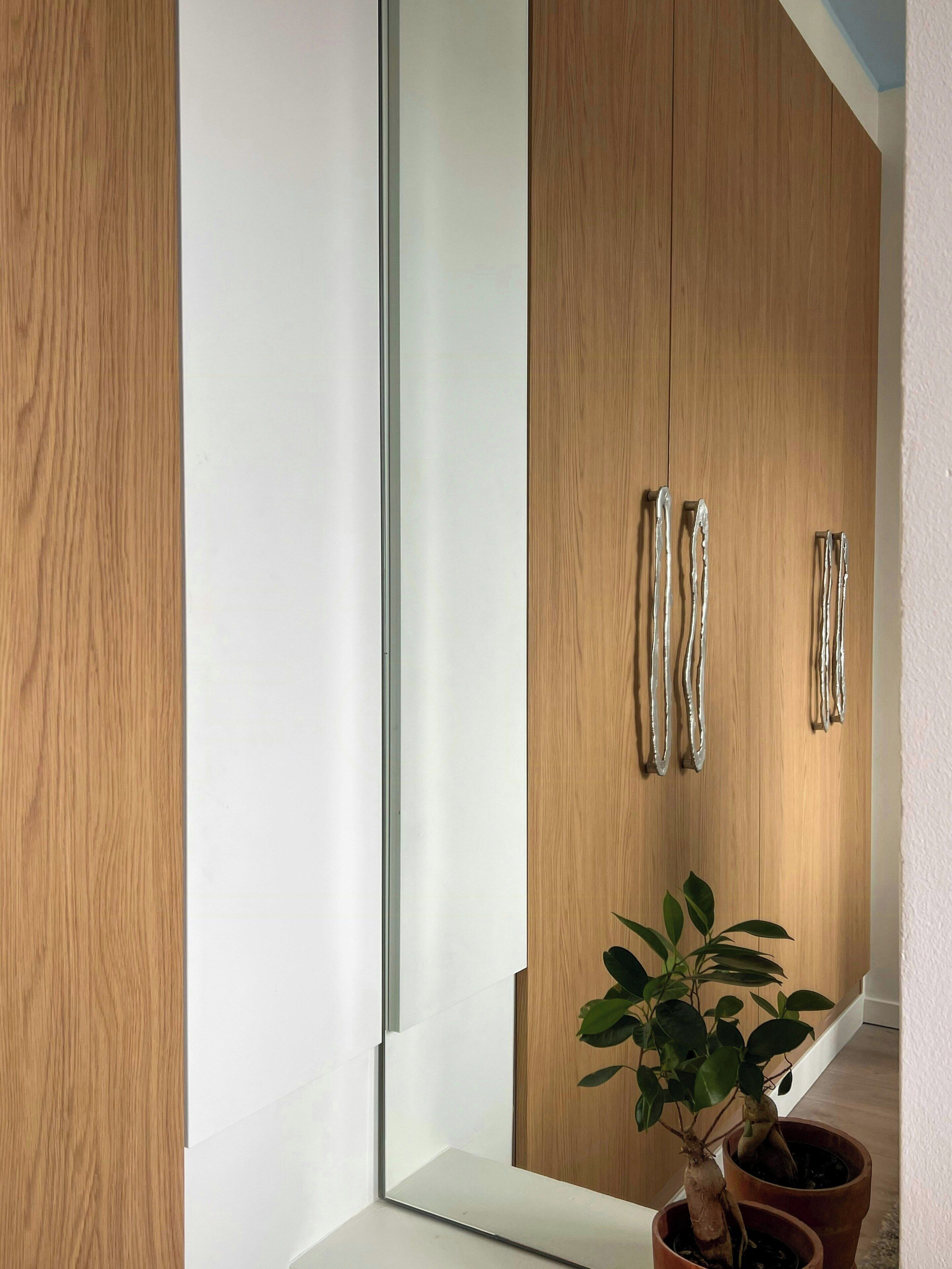 A modern interior with wooden cabinets and a potted plant.