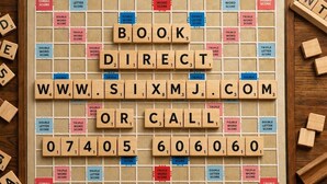 A Scrabble game board with words like 'BOOK,' 'DIRECT,' and 'CALL' on it. - Coyle House sleeps 7 free parking (Northamptonshire)