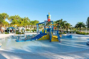 A water park with a large pool, slides, and a play structure. - Exclusive 6 bedroom family vacation home! (Kissimmee)