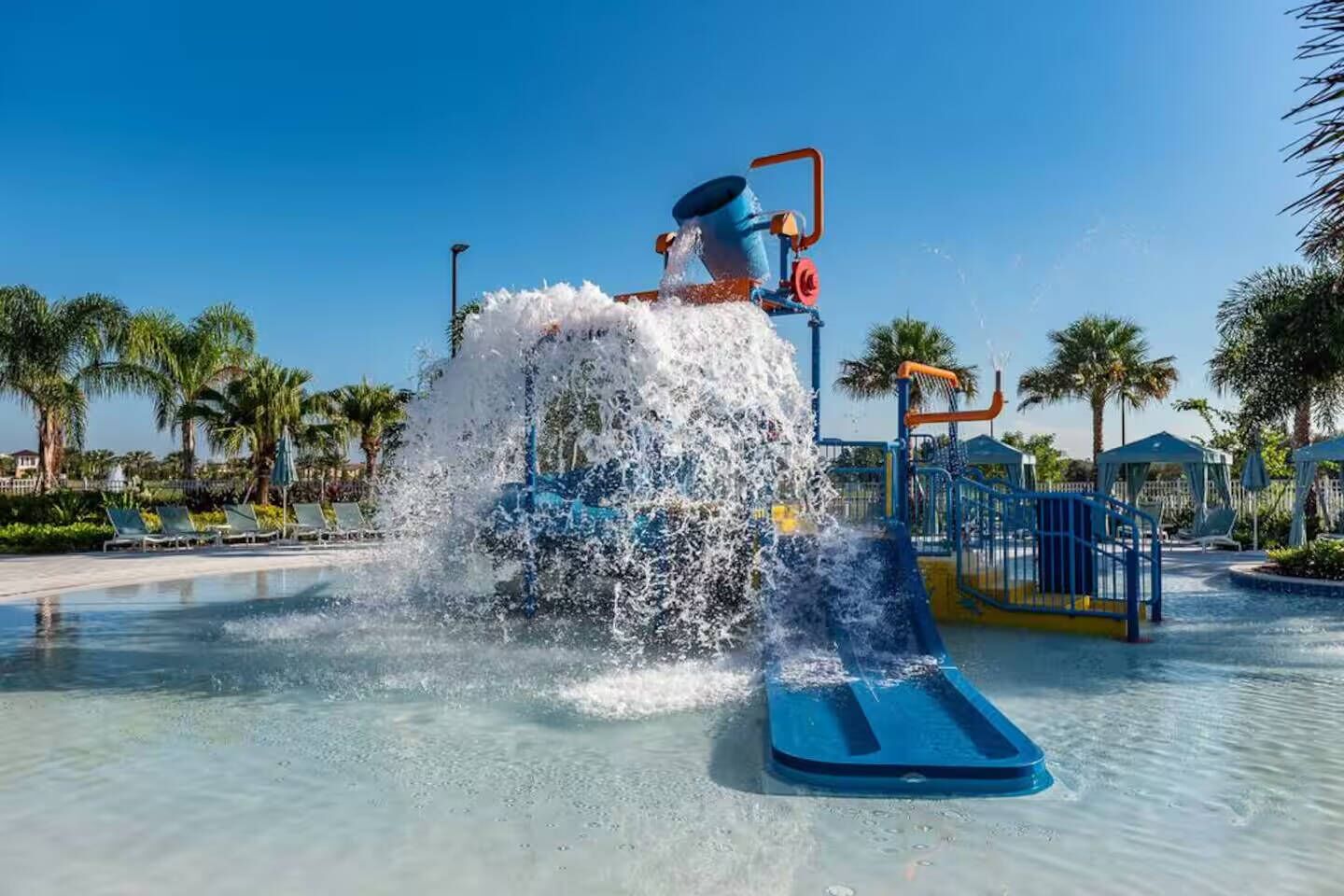 A water play area with a water slide and splash pad.