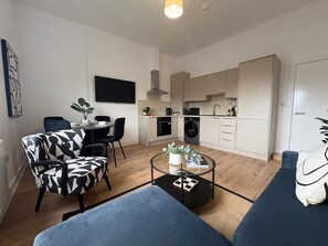 A modern apartment with a dining area, kitchen, and living space. - 2-Bath, 2 Bedroom, Free Parking – Birkdale (Southport)