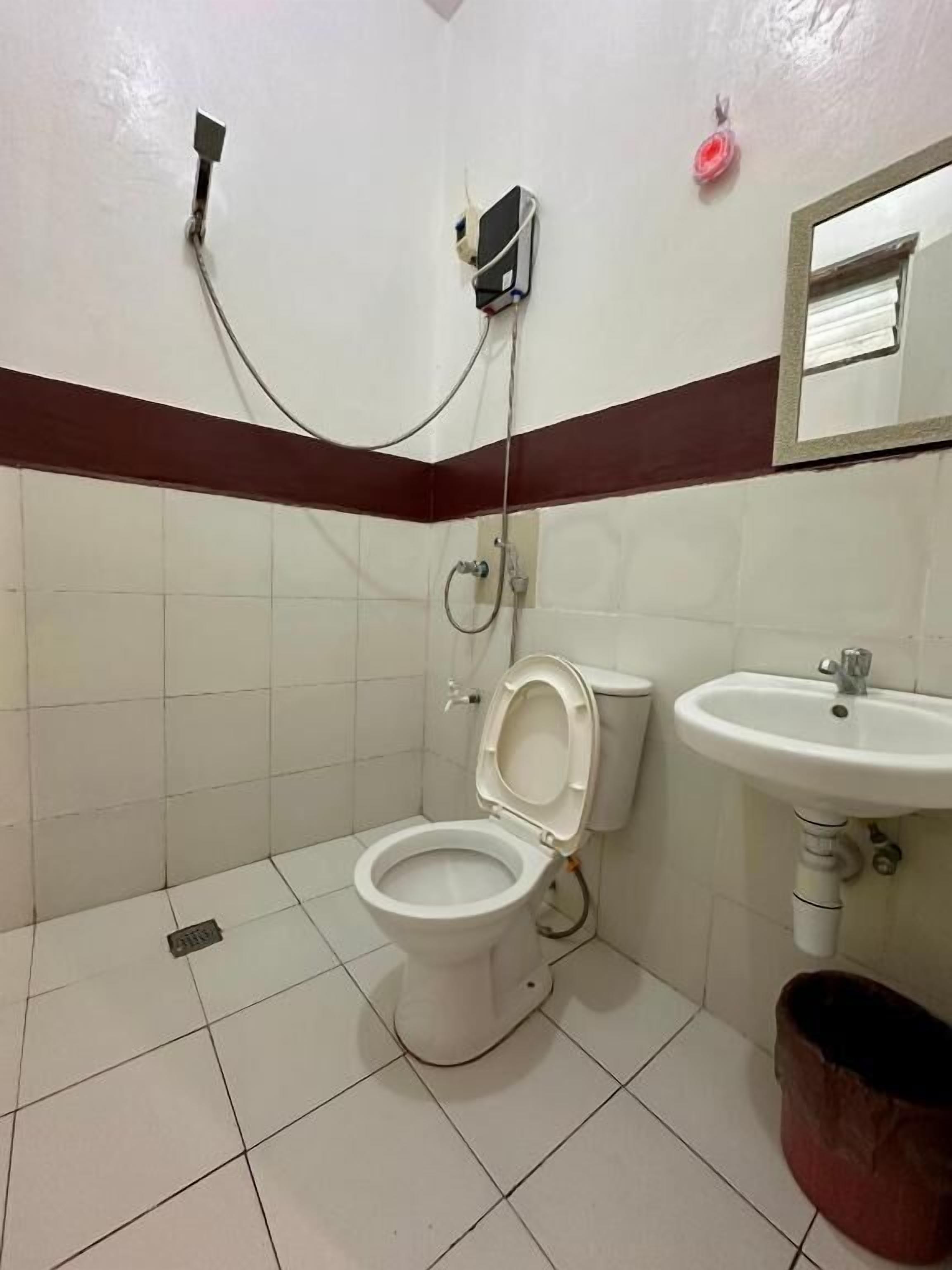 Un baño con inodoro, lavamanos y ducha.