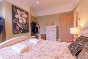 A bedroom with a bed, a dresser, a wardrobe, a painting, and a lamp. - Cosy flat |Center of Southend | Parking | Sleeps 4 - Pass the Keys (Southend-on-Sea)