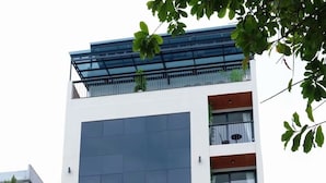A multi-story building with a modern design, featuring large windows and balconies. - La Van Residence (Da Nang)