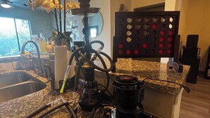 A kitchen with a hookah on the counter, a sink, and a window with a view. - City Views. Luxury Vibes. West Midtown Living. (Atlanta)