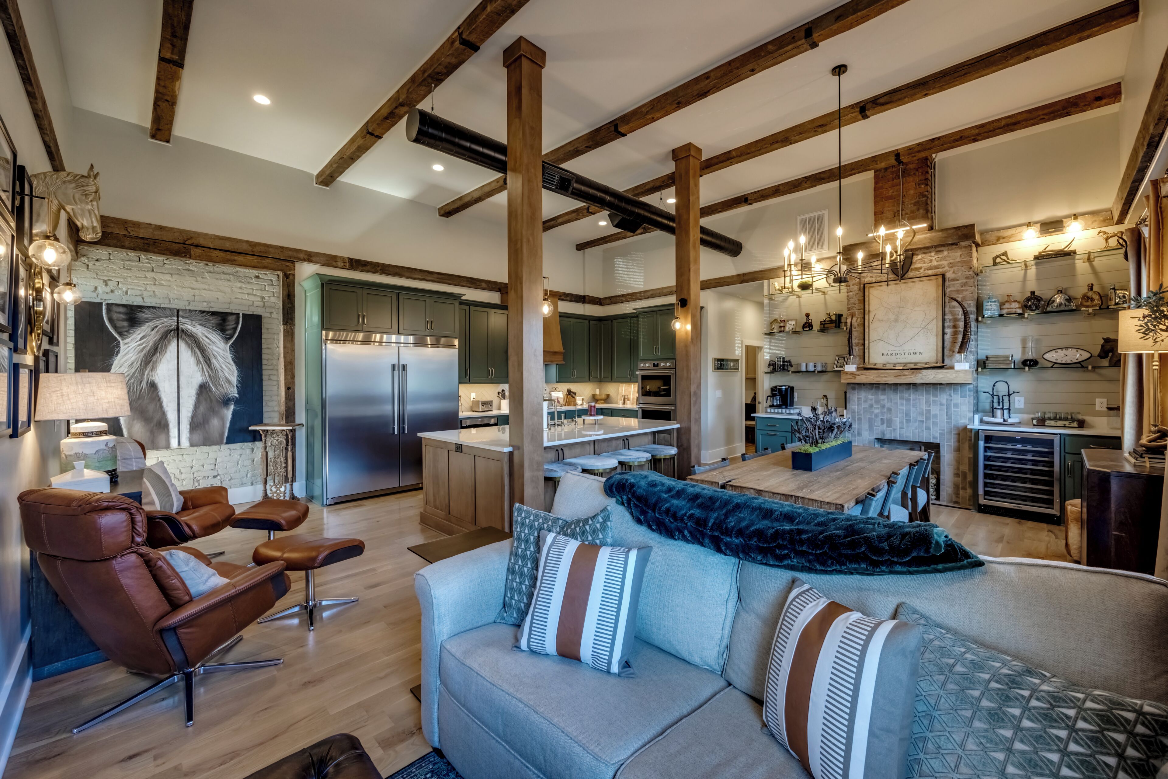 A spacious living area with a sofa, chairs, and a fireplace.